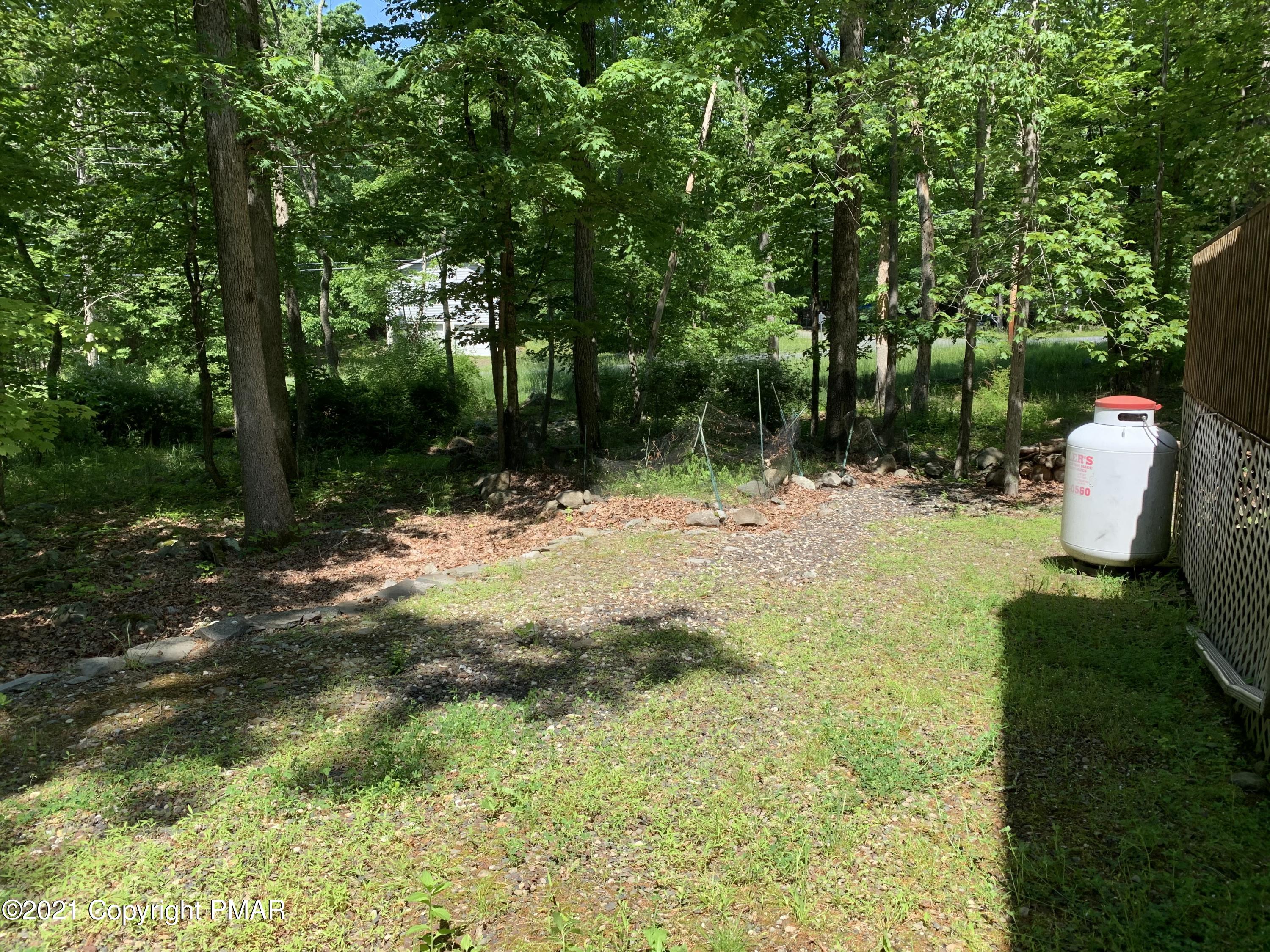 227 Canterbury Road Bushkill, PA 18324 - Photo 33 of 68 a backyard of a house with lots of green space