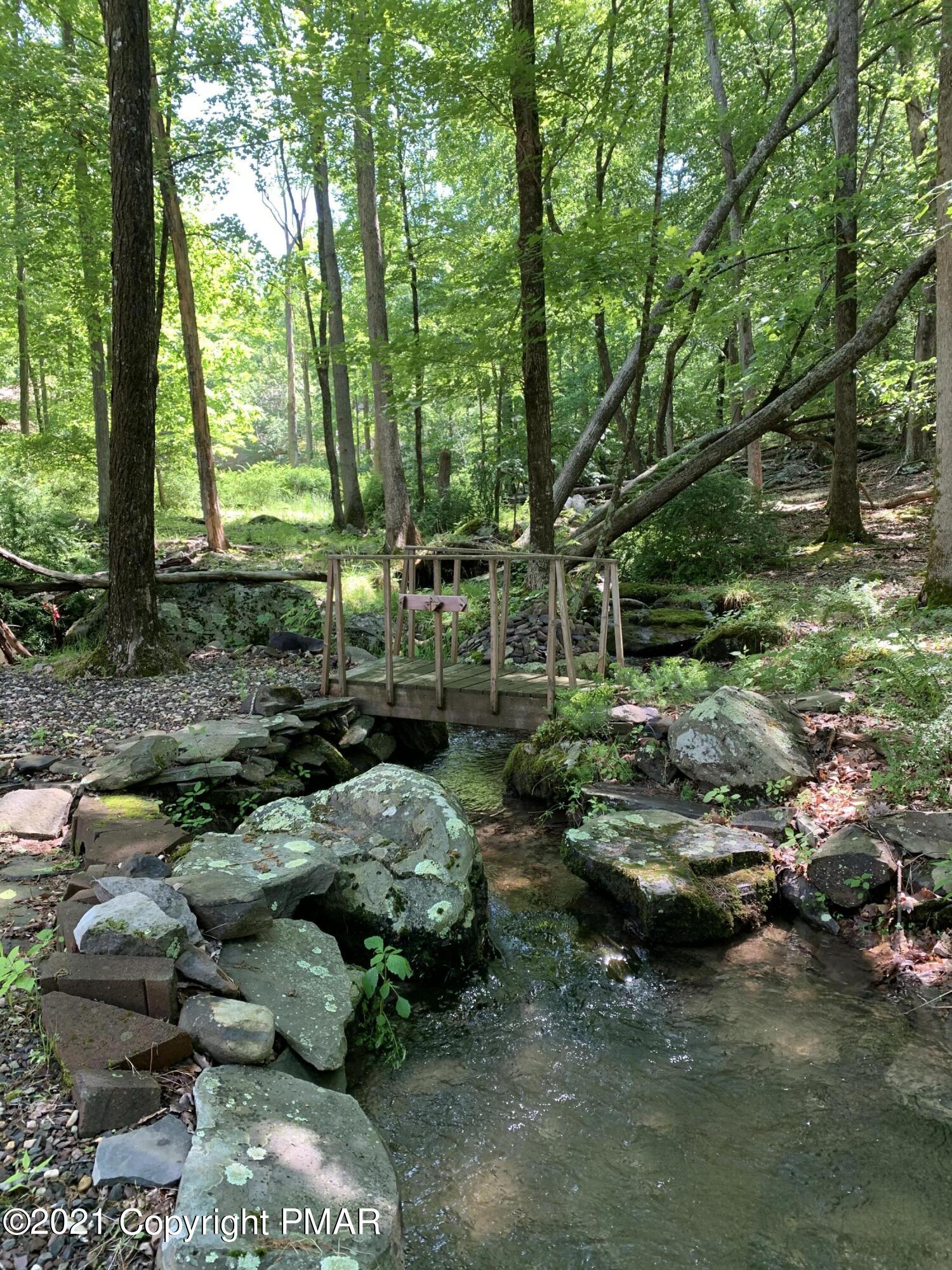 227 Canterbury Road Bushkill, PA 18324 - Photo 5 of 68 a backyard of a house with lots of green space
