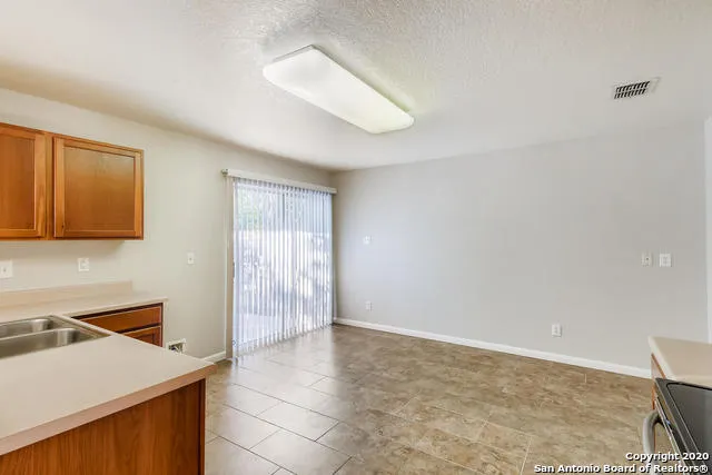 a view of a kitchen with a sink cabinets and a window