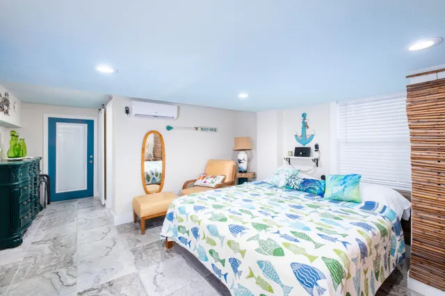 a kitchen with a dining table chairs and large windows