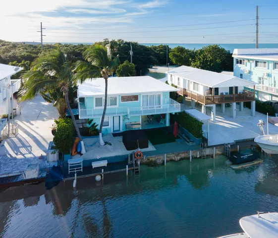 a front view of a house with plants