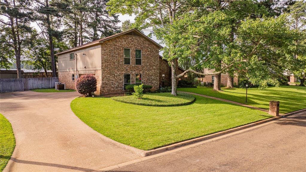 108 Wildwood Street Longview, TX 75604 - Photo 1 of 1 a view of a house with backyard and trees