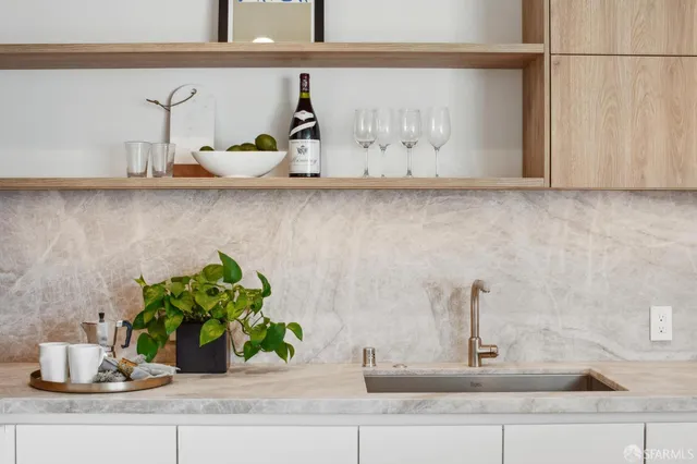 a kitchen sink with a granite countertop
