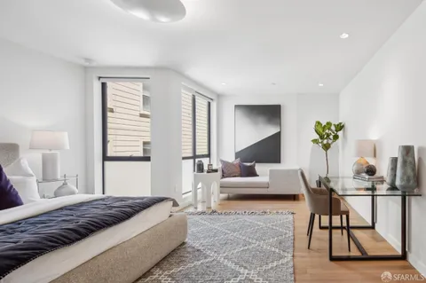 a bedroom with a bed and couch