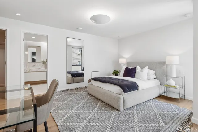 a bedroom with a large bed and a couch