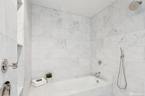 a bathroom with a bathtub and shower