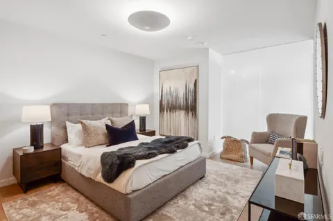 a bedroom with a bed and chair