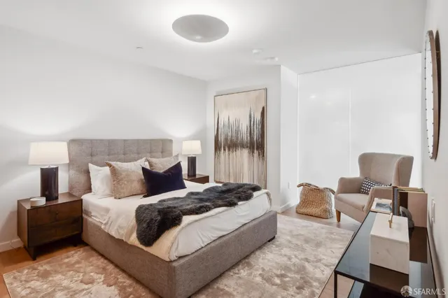 a bedroom with a bed and chair