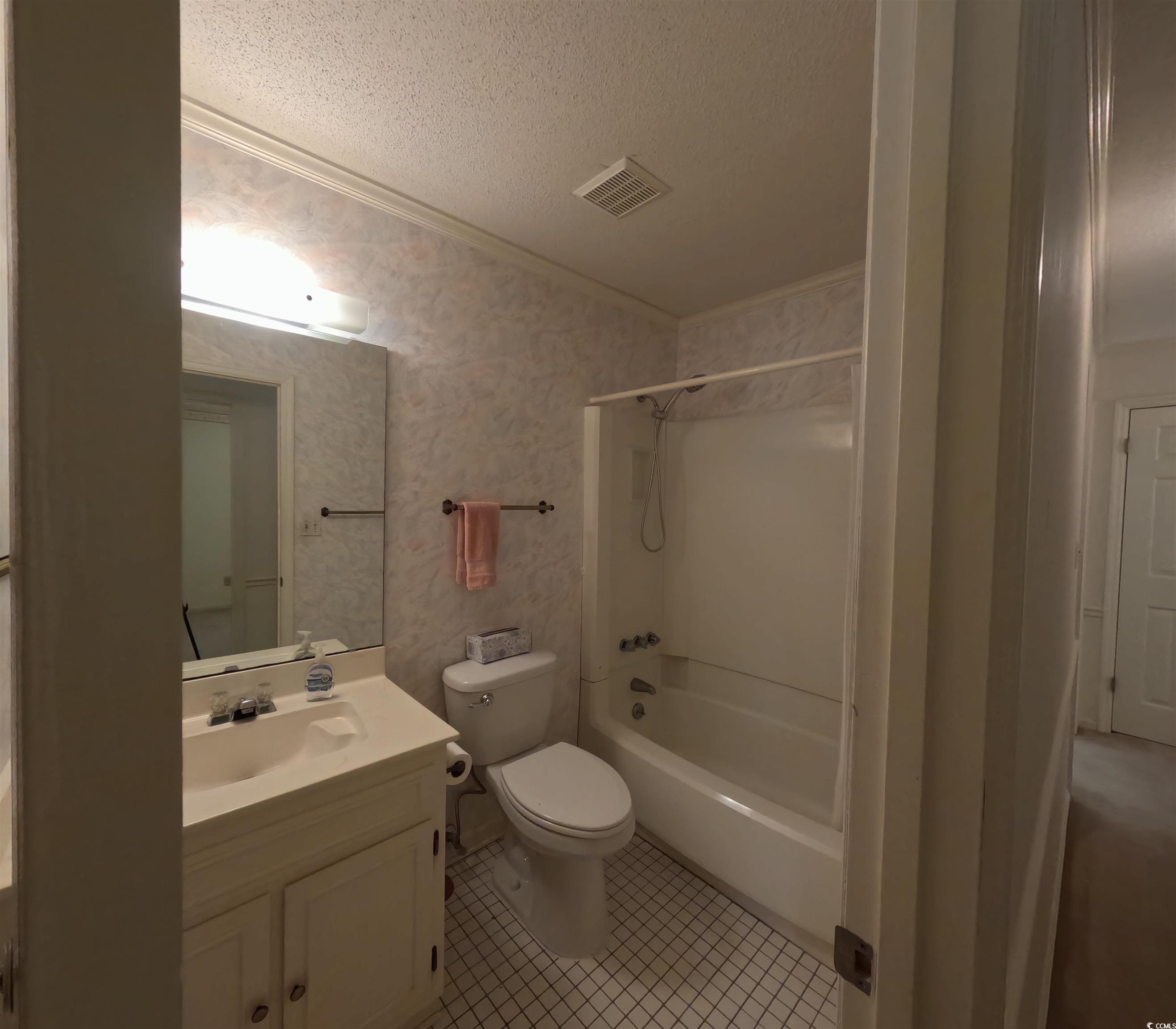 5580 Green Bay Circle Myrtle Beach, SC 29588 - Photo 11 of 36 Bathroom with vanity, bathing tub / shower combination, a textured ceiling, crown molding, and tile patterned floors