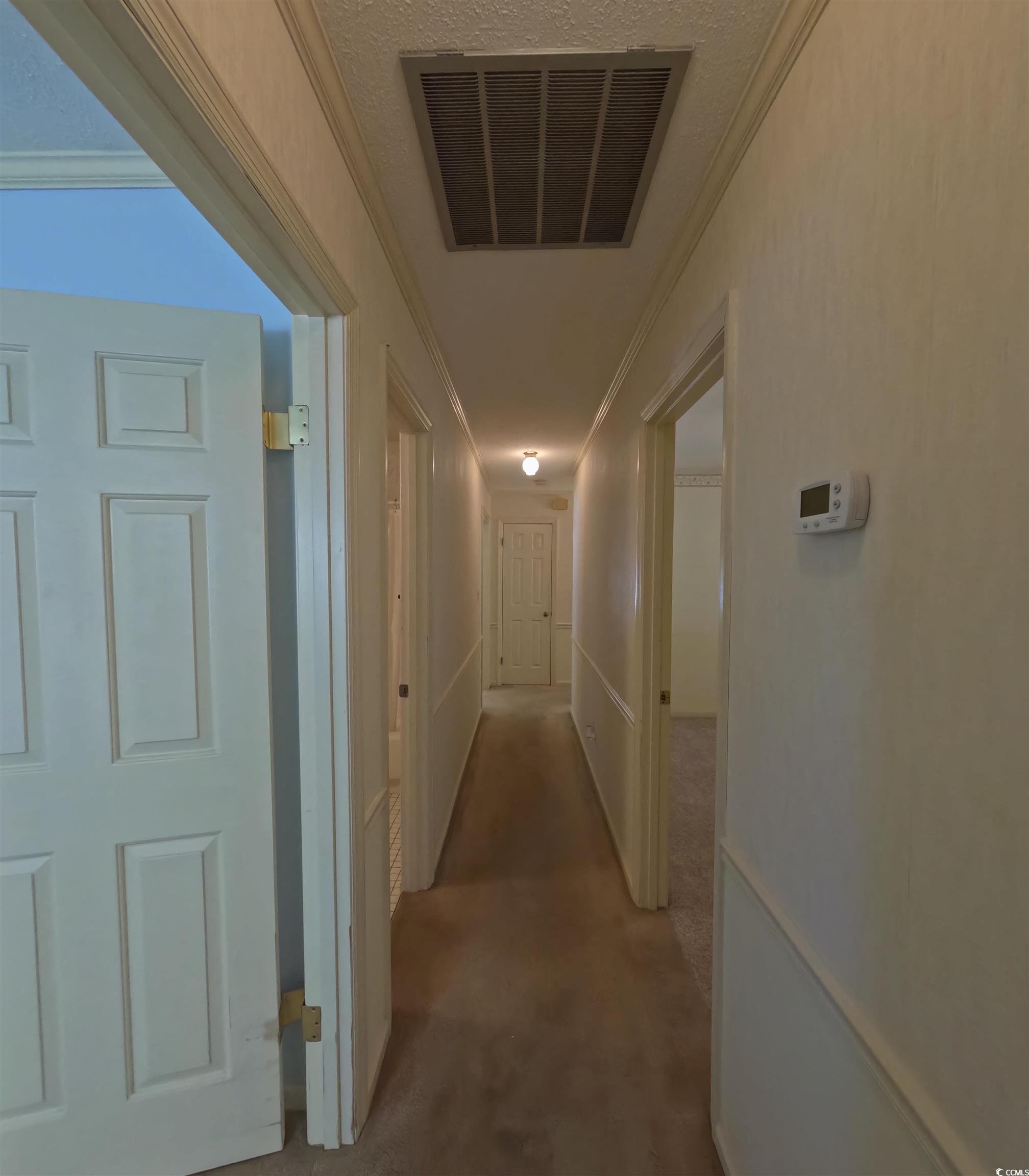 5580 Green Bay Circle Myrtle Beach, SC 29588 - Photo 16 of 36 Hallway featuring crown molding and carpet flooring