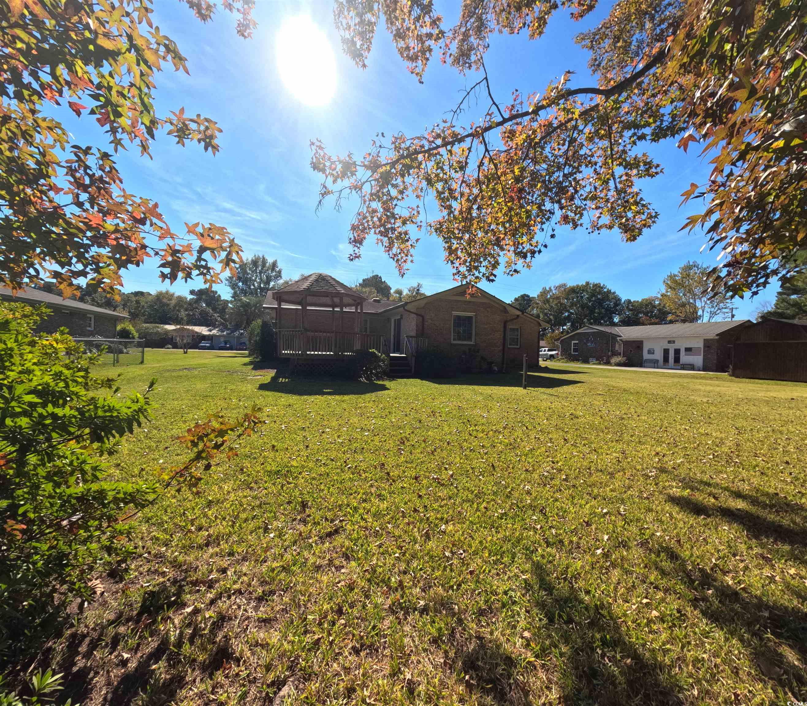5580 Green Bay Circle Myrtle Beach, SC 29588 - Photo 18 of 36 View of green lawn with a sunroom