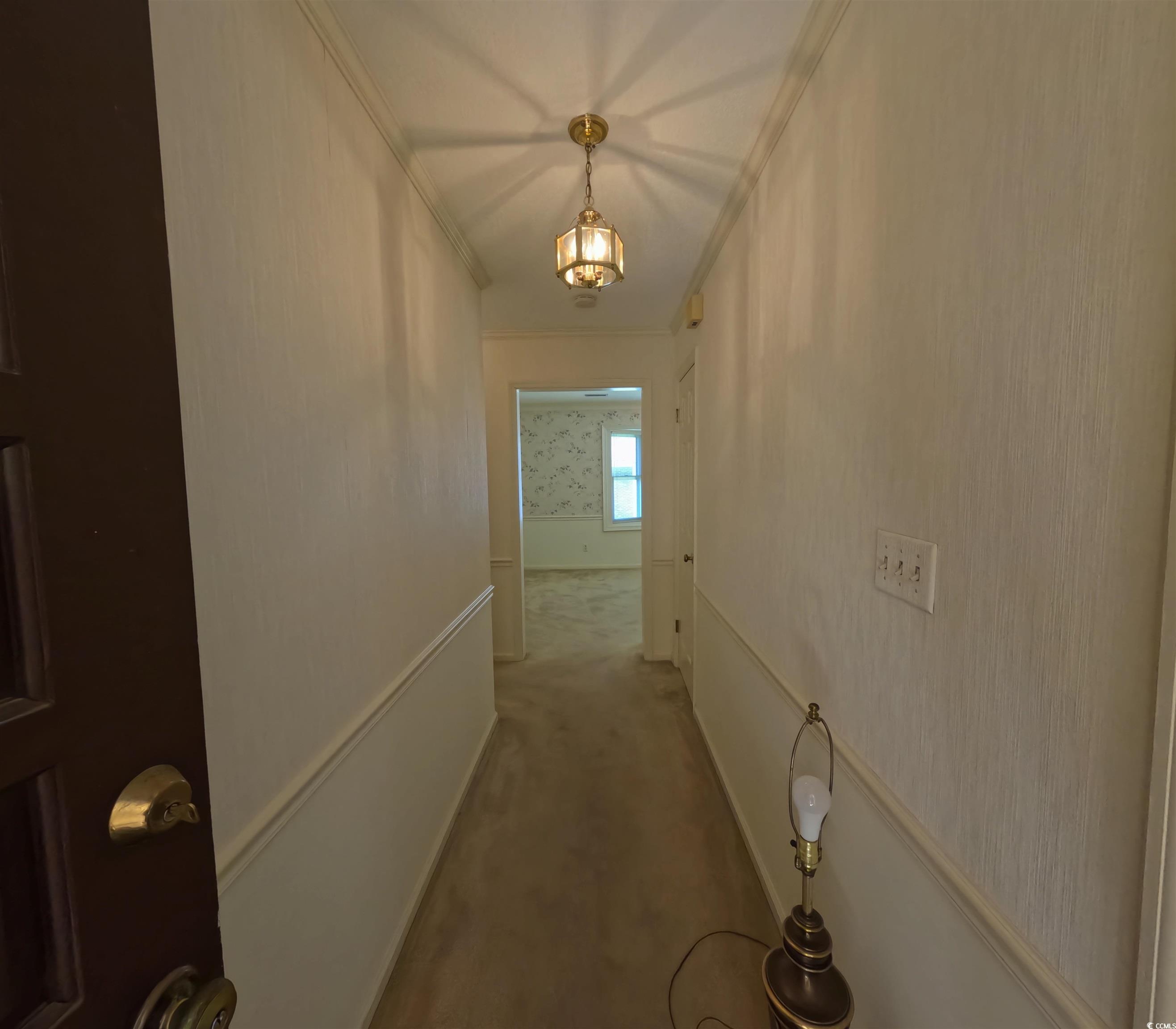 5580 Green Bay Circle Myrtle Beach, SC 29588 - Photo 2 of 36 Hallway featuring ornamental molding, carpet floors, a wainscoted wall, and wallpapered walls