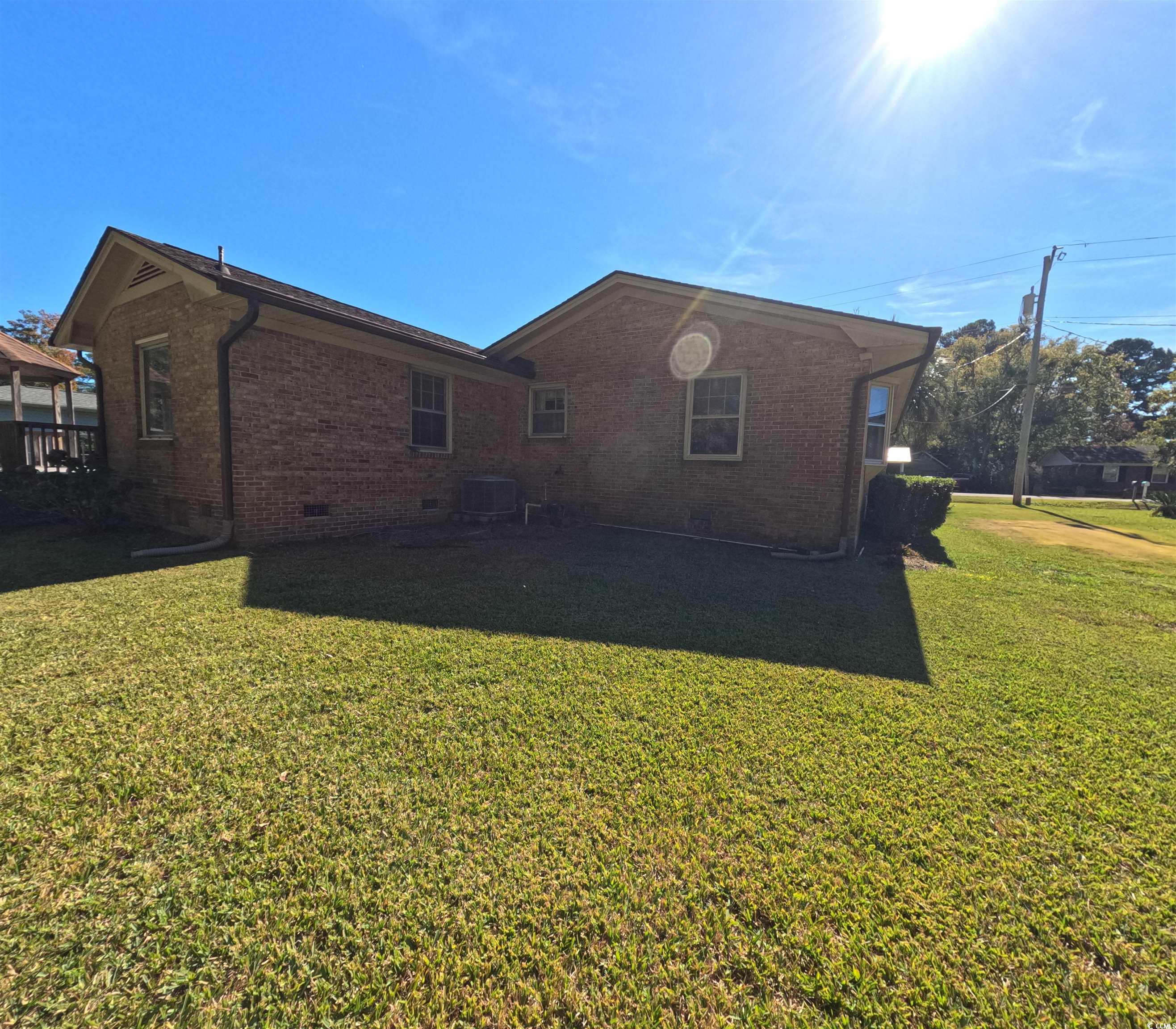 5580 Green Bay Circle Myrtle Beach, SC 29588 - Photo 23 of 36 Back of property with crawl space, brick siding, and a lawn