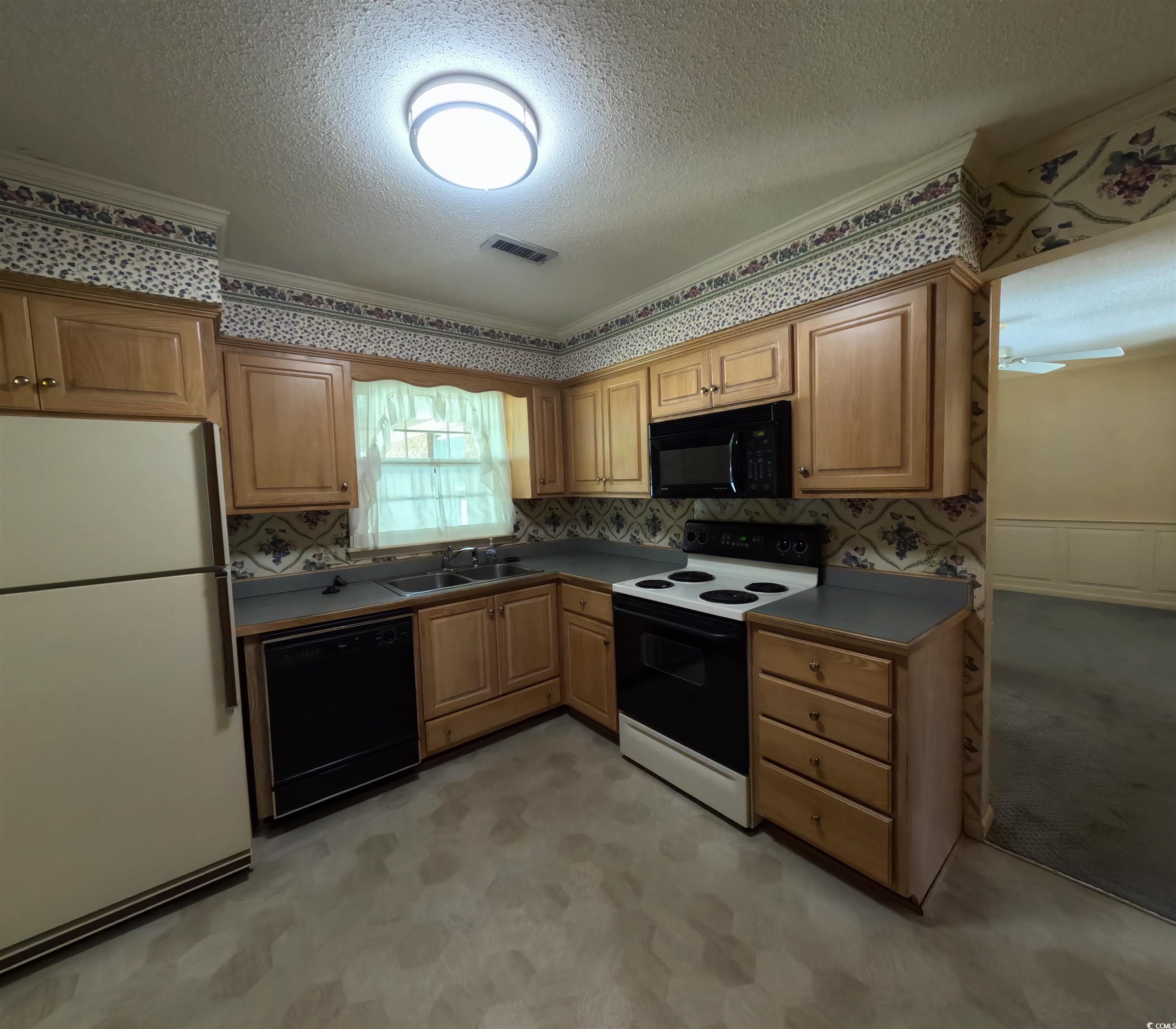 5580 Green Bay Circle Myrtle Beach, SC 29588 - Photo 31 of 36 Kitchen with black appliances, a textured ceiling, crown molding, dark countertops, and tasteful backsplash