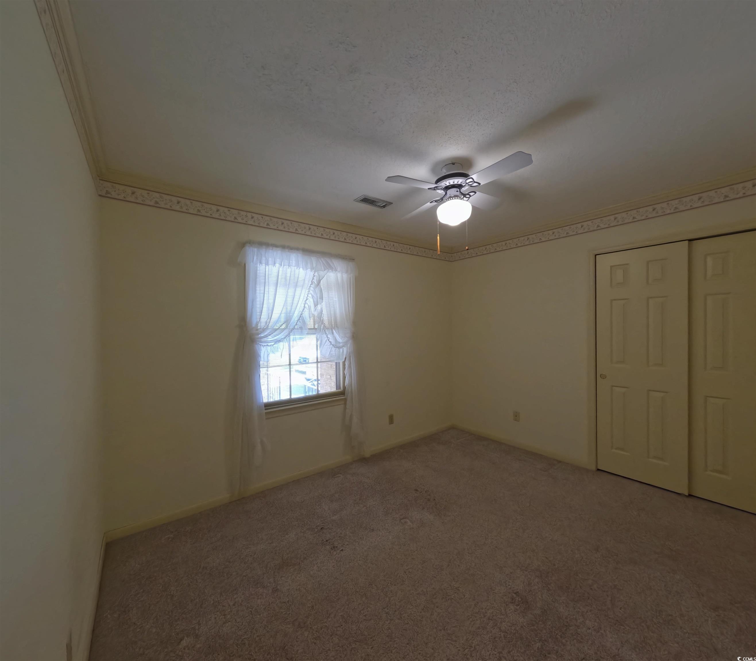 5580 Green Bay Circle Myrtle Beach, SC 29588 - Photo 9 of 36 Carpeted spare room featuring a textured ceiling and ceiling fan