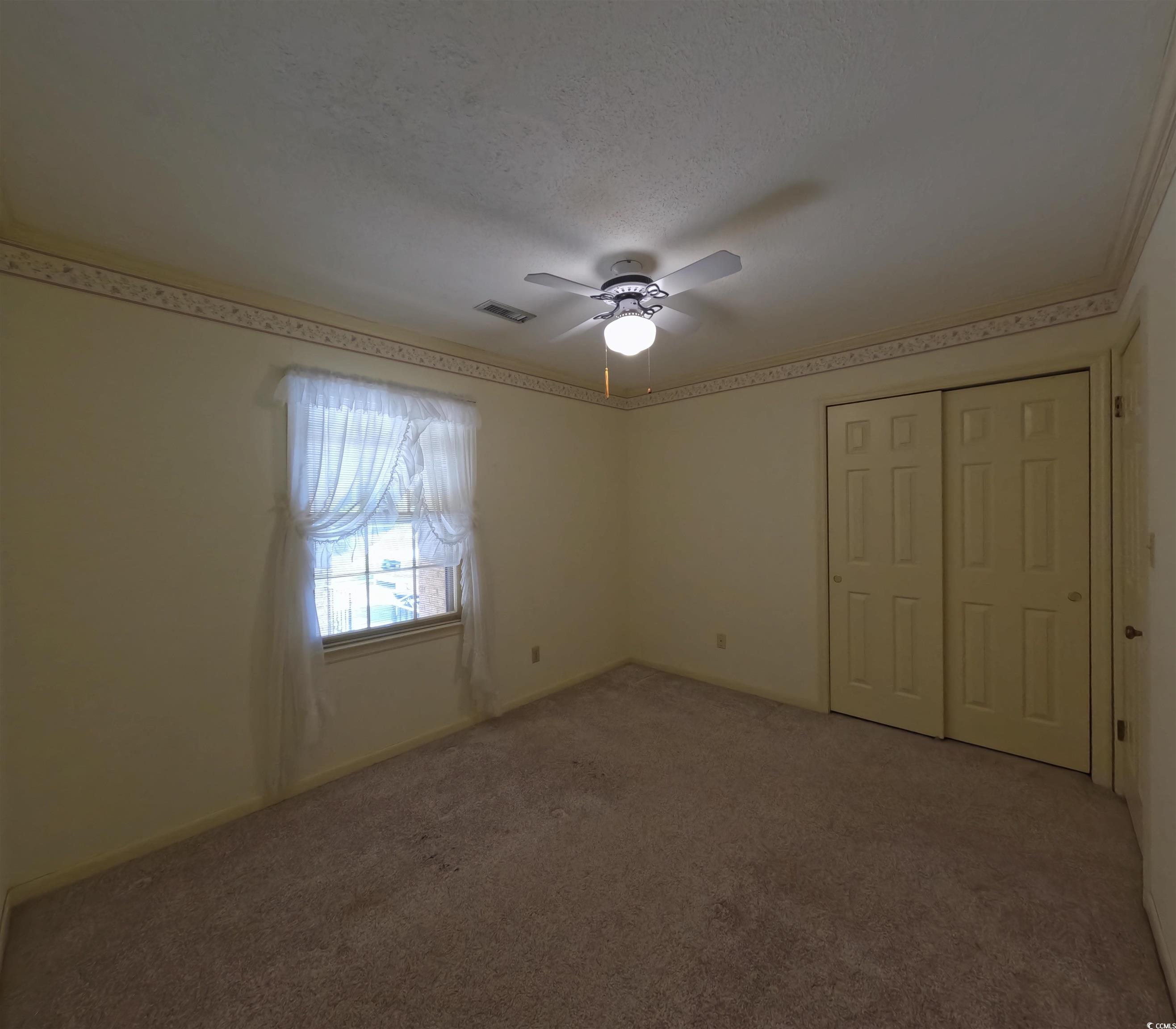 5580 Green Bay Circle Myrtle Beach, SC 29588 - Photo 10 of 36 Unfurnished bedroom with a closet, carpet flooring, ceiling fan, and a textured ceiling