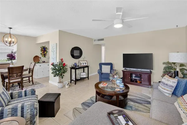 a living room with furniture and a mirror