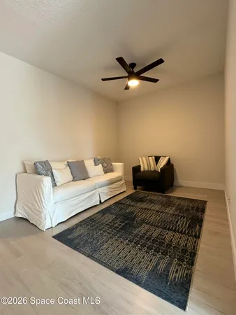 a living room with furniture and a rug