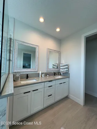 a bathroom with double sink and a mirror