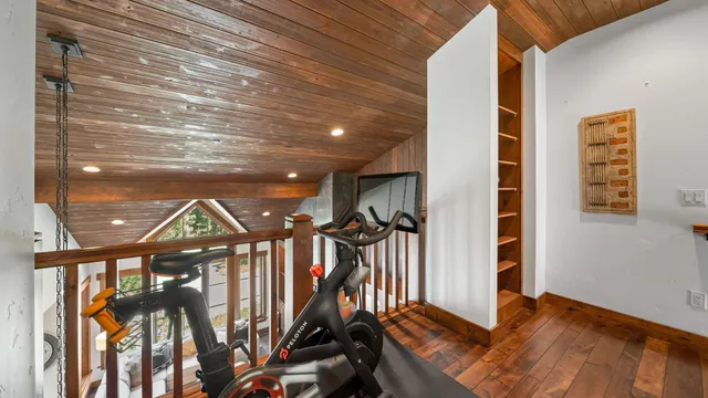 a spacious bedroom with a bed and a large window with the outer view