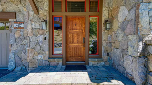 a room with kitchen island granite countertop a stove and a wooden cabinets