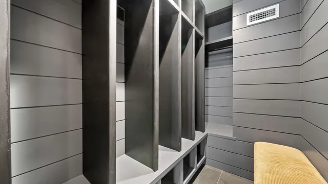 a balcony with wooden floor table and chairs