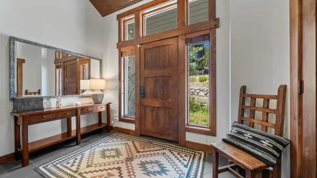 a living room with furniture a flat screen tv and a large window