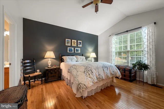 a bedroom with bed and wooden floor