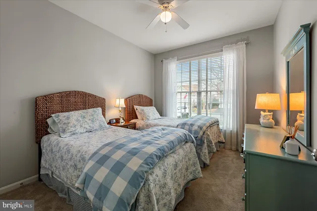 a bedroom with a large bed and a large window