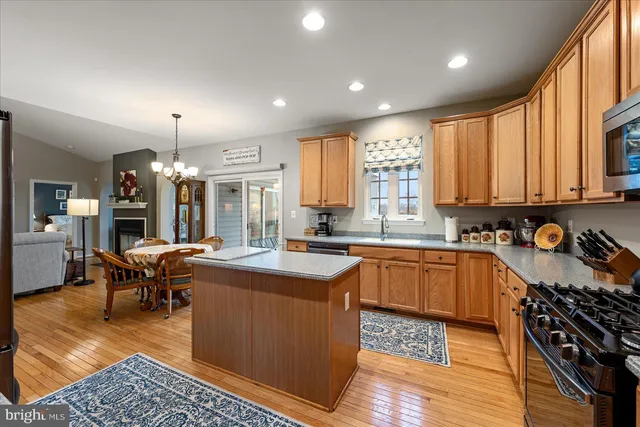 a large kitchen with lots of counter space and stainless steel appliances