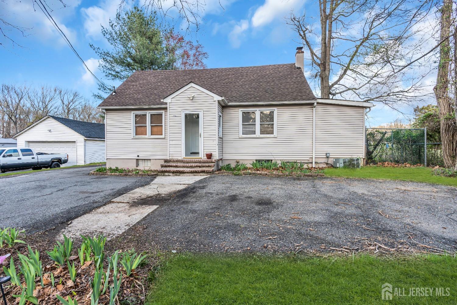 a view of a yard in front of a house with large tree