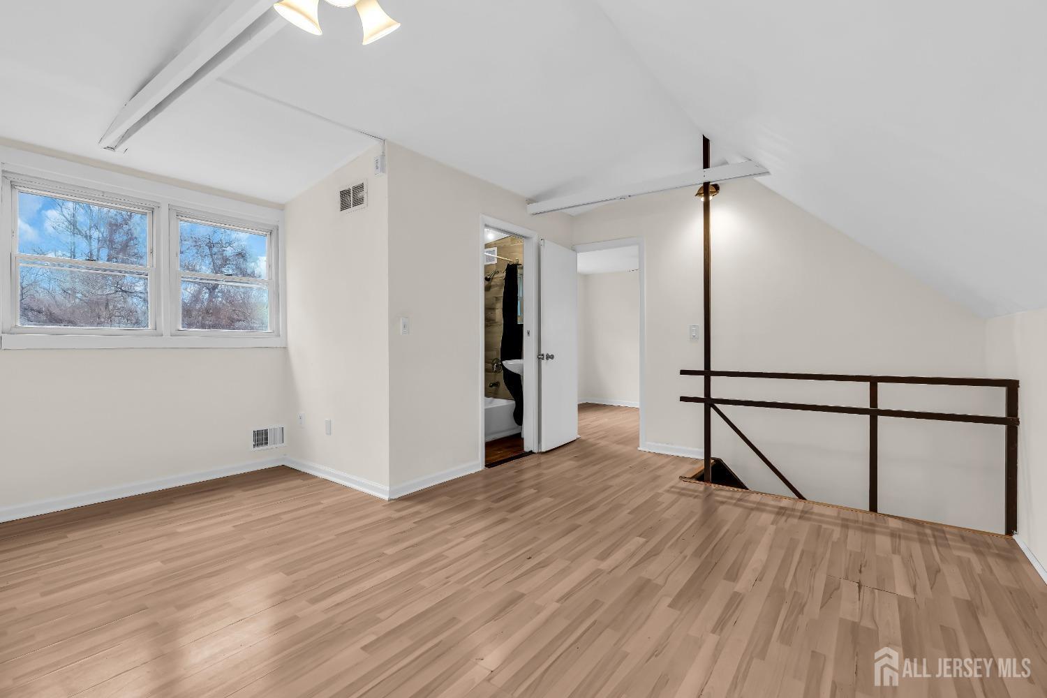 1550 Englishtown Road Old Bridge, NJ 08857 - Photo 11 of 20 a view of an empty room with wooden floor and a window