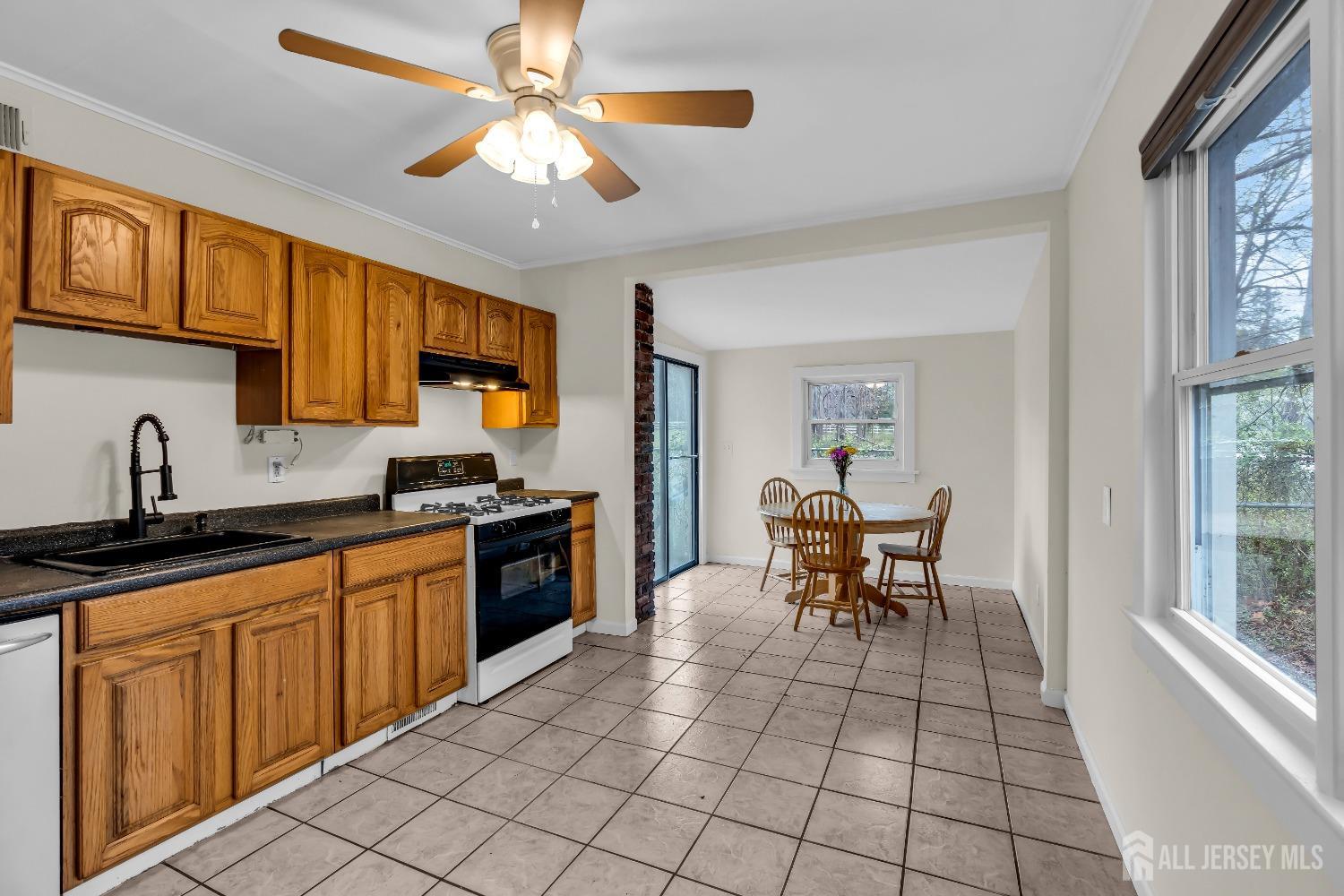 1550 Englishtown Road Old Bridge, NJ 08857 - Photo 3 of 20 a kitchen with stainless steel appliances granite countertop a sink and a refrigerator