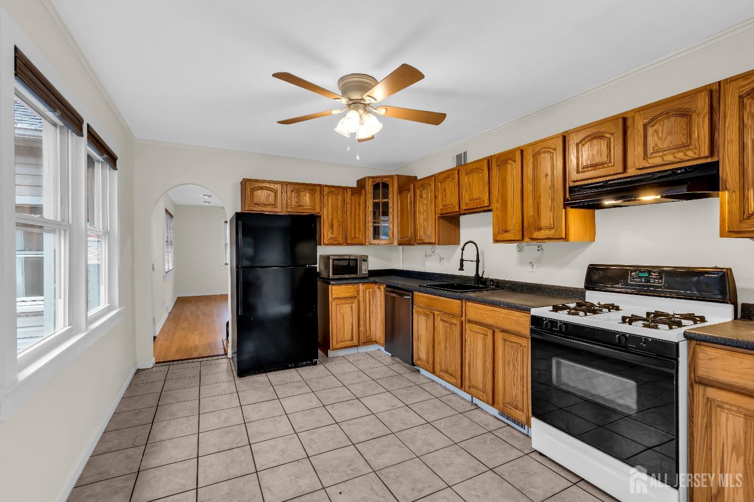 1550 Englishtown Road Old Bridge, NJ 08857 - Photo 4 of 20 a kitchen with granite countertop a stove cabinets and refrigerator
