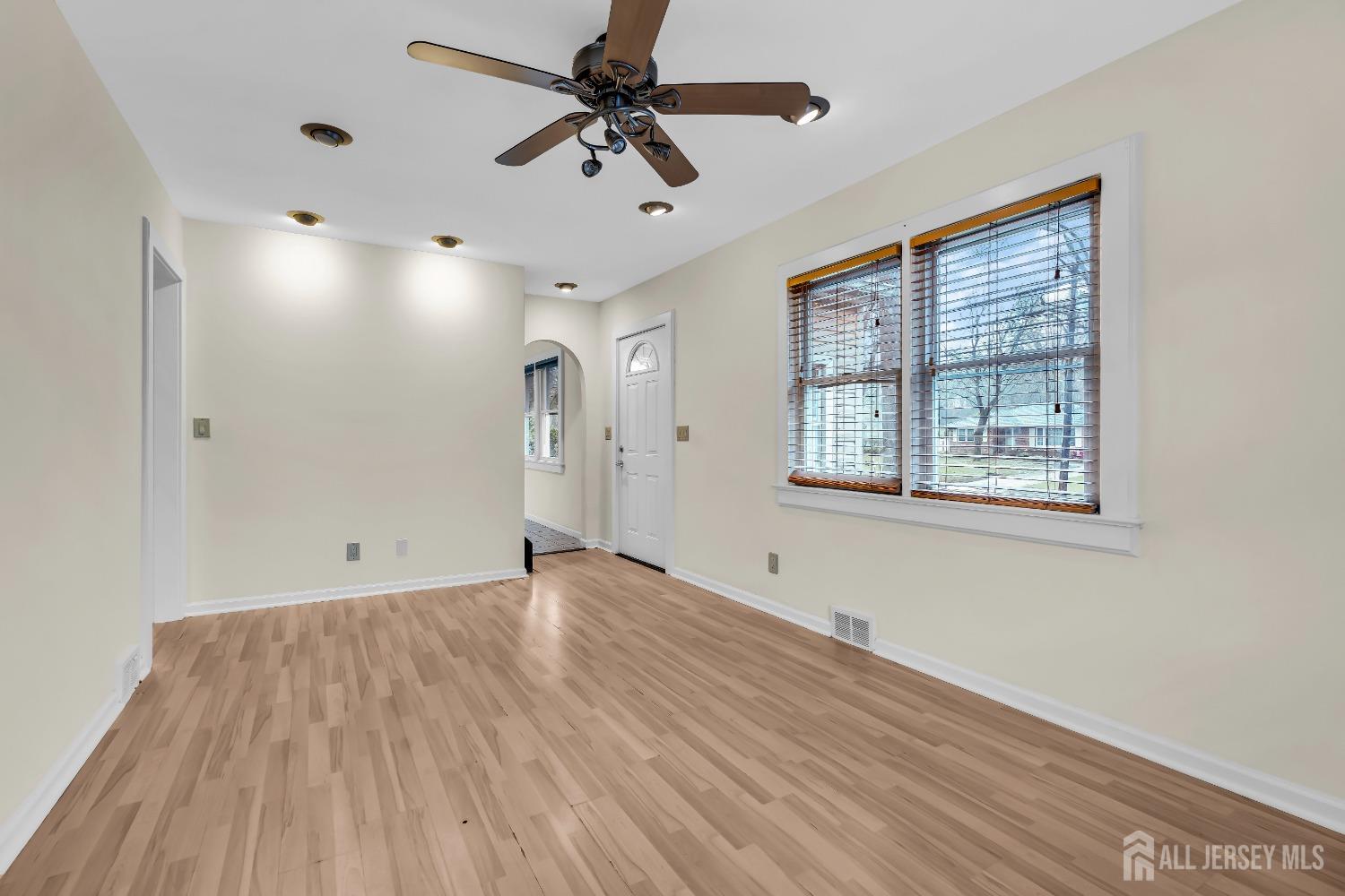 1550 Englishtown Road Old Bridge, NJ 08857 - Photo 6 of 20 a view of an empty room with a window and wooden floor