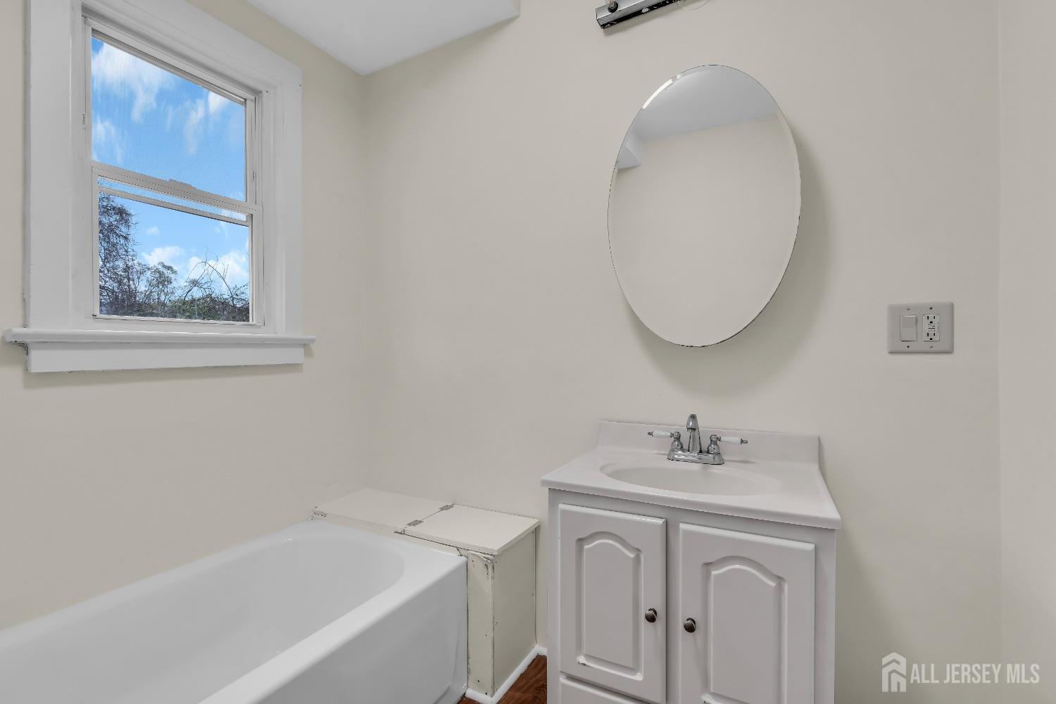 1550 Englishtown Road Old Bridge, NJ 08857 - Photo 7 of 20 a bathroom with a bathtub a sink and a mirror