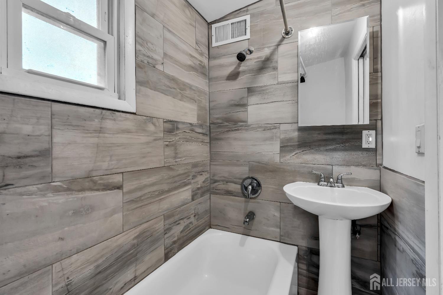 1550 Englishtown Road Old Bridge, NJ 08857 - Photo 9 of 20 a bathroom with a sink a mirror and shower