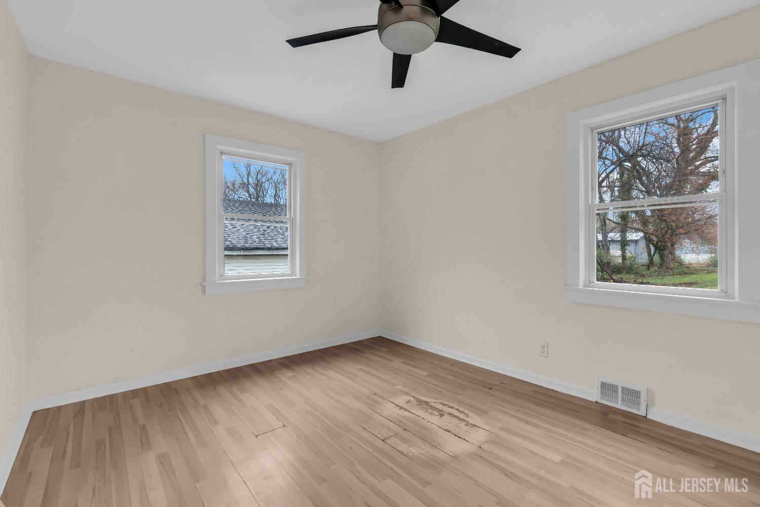 1550 Englishtown Road Old Bridge, NJ 08857 - Photo 10 of 20 a view of an empty room with a window and wooden floor