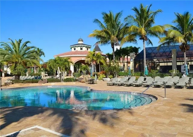 a view of a swimming pool with palm trees