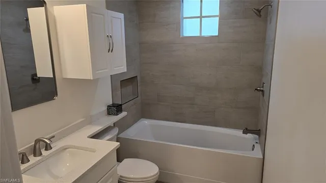 a bathroom with a sink toilet and bathtub