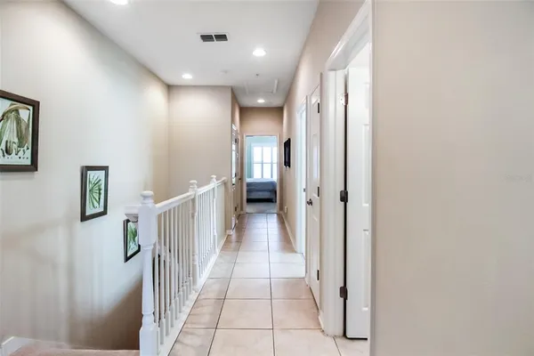 a view of a hallway with a furniture and a bathroom