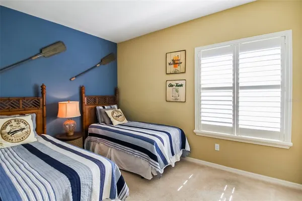 a bedroom with two beds and a window