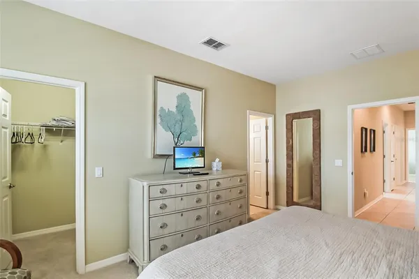 a bedroom with a bed and a dresser in it