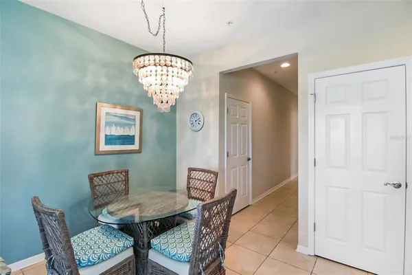 a view of a dining room with furniture and chandelier