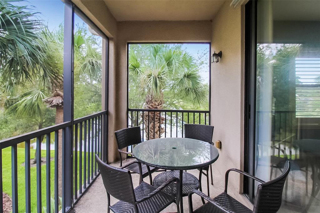 7333 Skybird Road Bradenton, FL 34209 - Photo 32 of 35 a view of a balcony with table and chairs