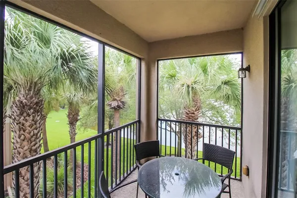 a view of a porch with furniture and garden