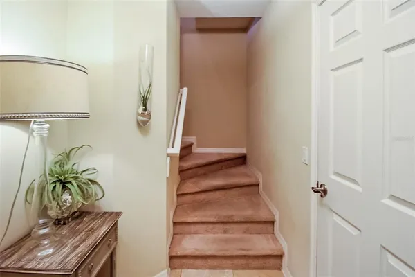 a view of staircase with wooden floor and a potted plant
