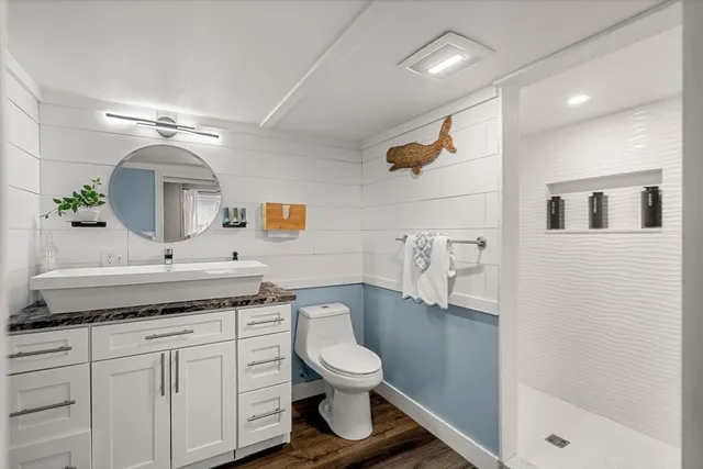 a bathroom with a sink a mirror and bathtub