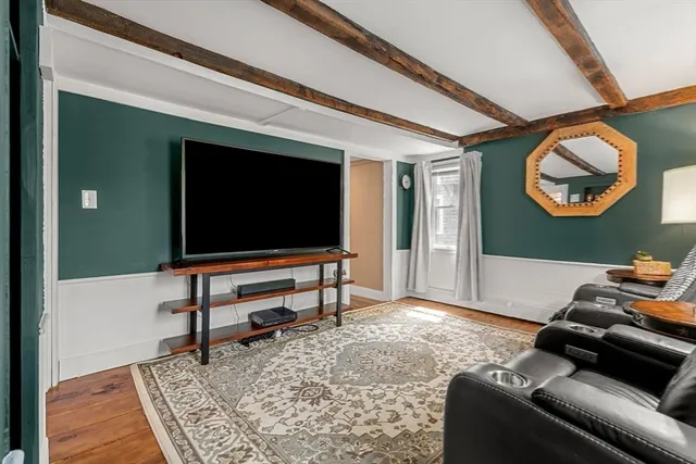 a living room with furniture and a dresser