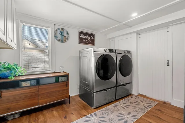 a balcony with wooden floor table and chairs